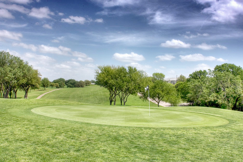 Golf course green with flag and hole