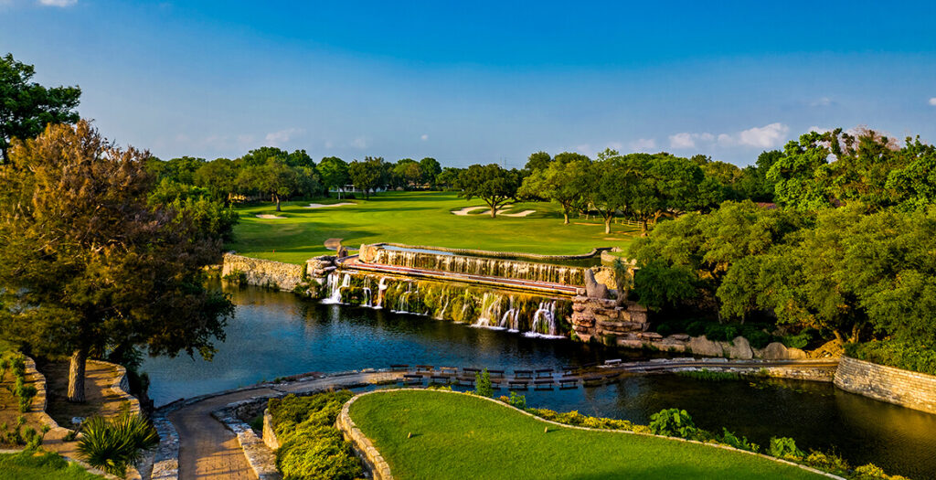 Golf course with waterfall, rivers, and trees