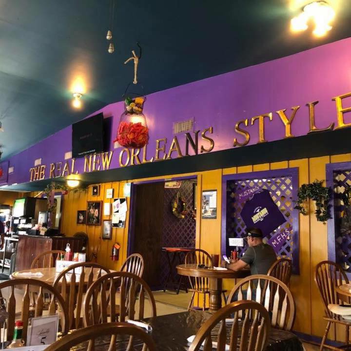 New Orleans Style Restaurant interior
Chairs and tables and a man on his phone