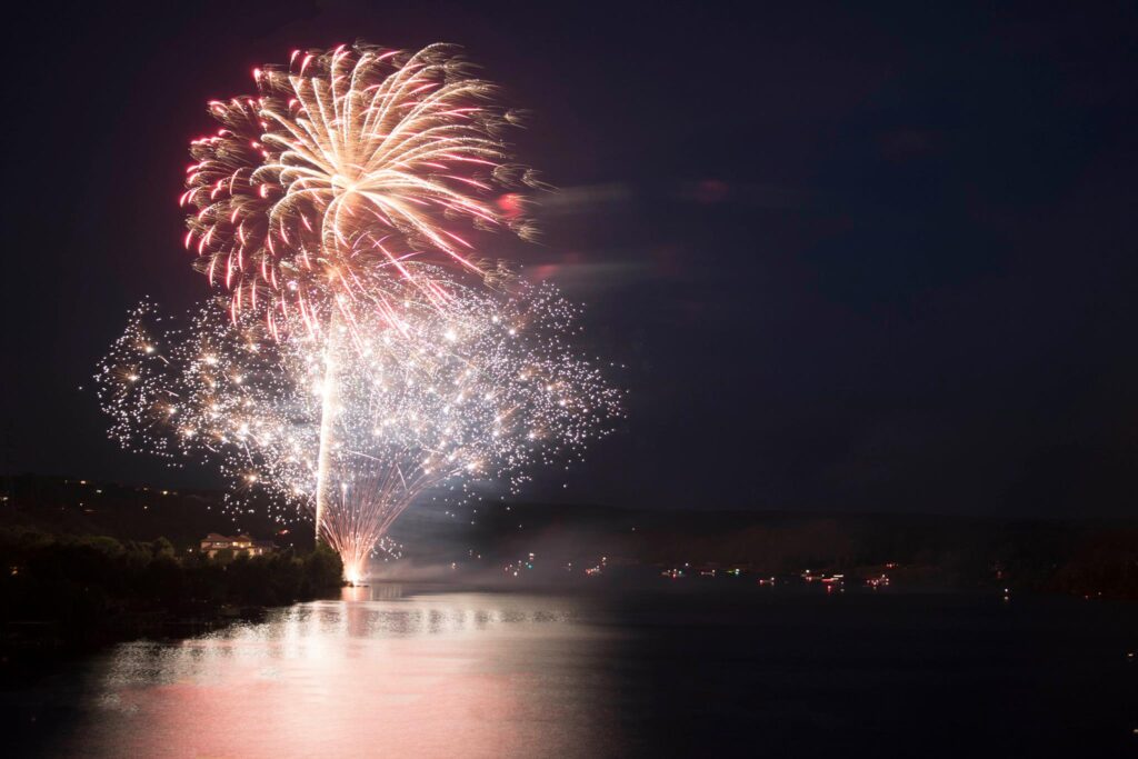 Fireworks over Lake Marble falls at night.
