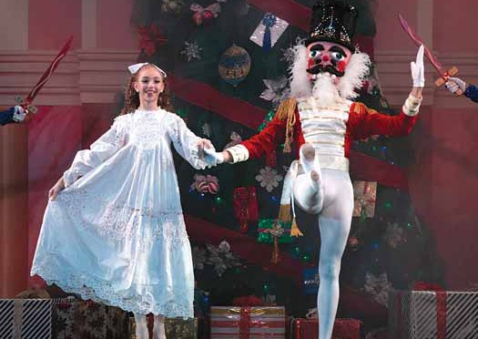 Clara and the Nutcracker in front of a Christmas tree

