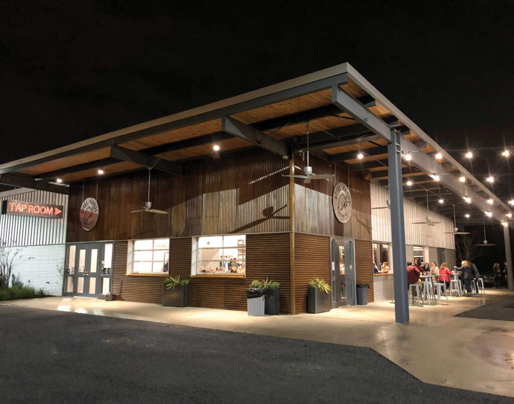 Steel Hands Brewery; a building with a patio and metal siding