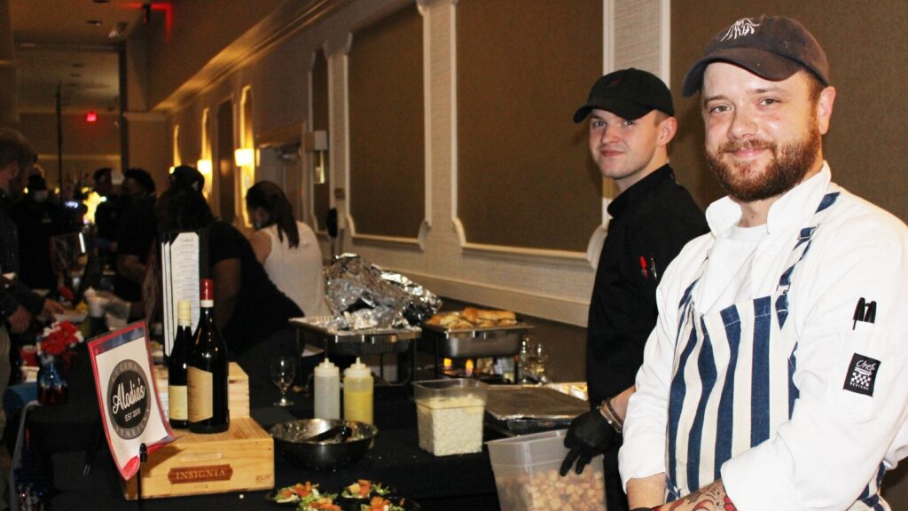 two men preparing meals at Taste of Lake Murray