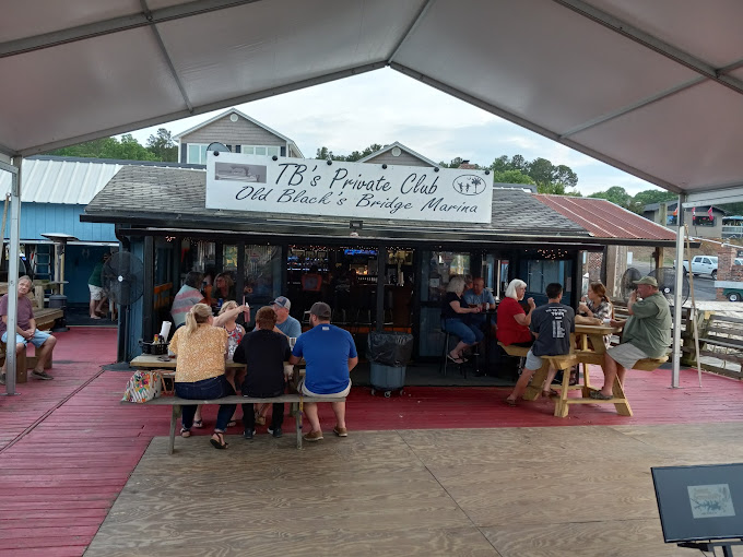 people sitting, eating, and drinking at TB's Shack