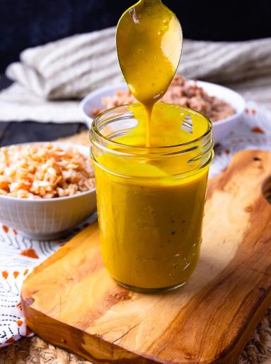 Carolina barbecue saw being spooned into a jar
