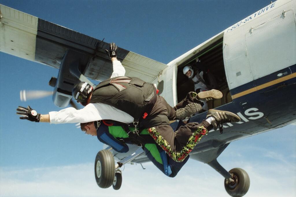 tandem team jumping out of a plane