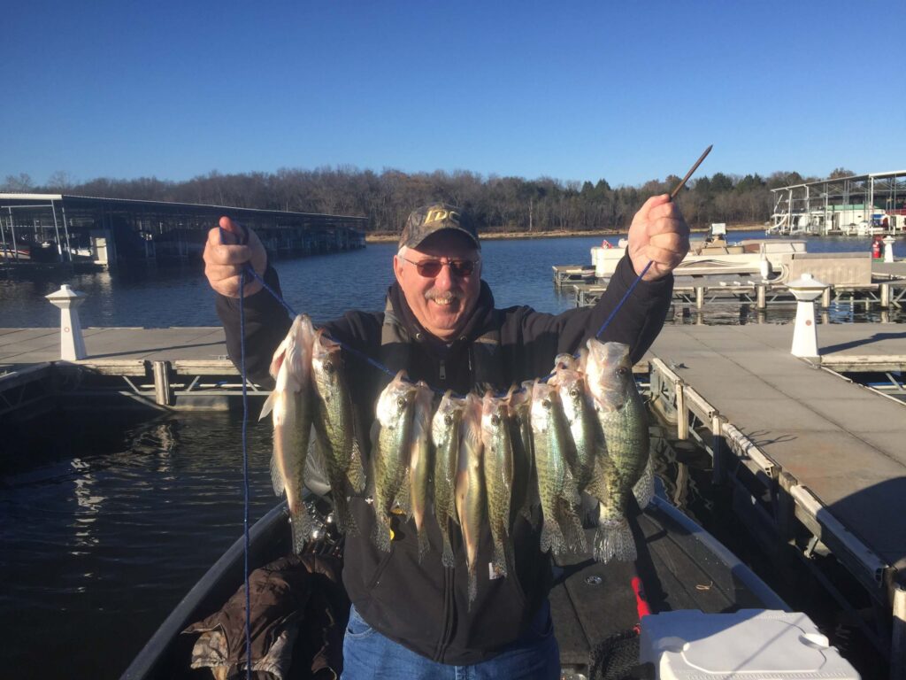 Fishermen holding a string of crappie