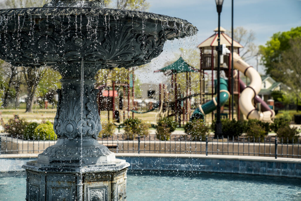 fountain in front of a park