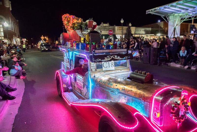 Old-fashioned car decorated for seasonal parade. 