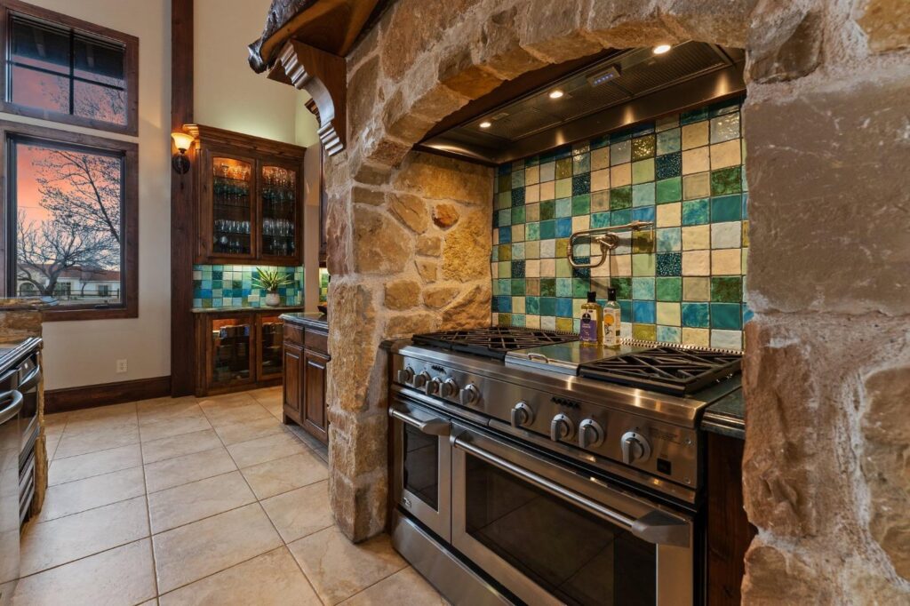 a range in a kitchen with a blue and white backsplash
