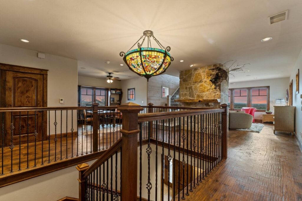 upstairs area with a chandelier and wood floors