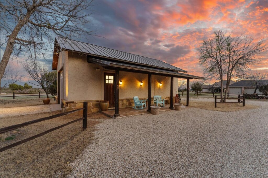 building with a porch and gravel road