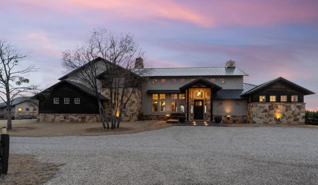 outside of a house with a metal roof and stone accents