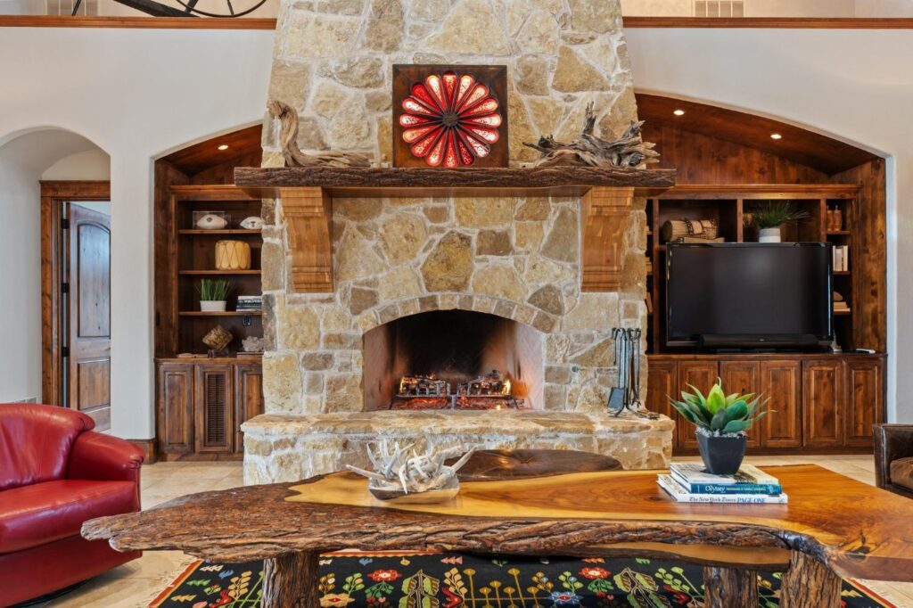 a fireplace and wooden table in a living room