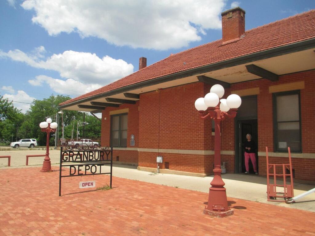 a brick building and a sign that says Granbury Depot