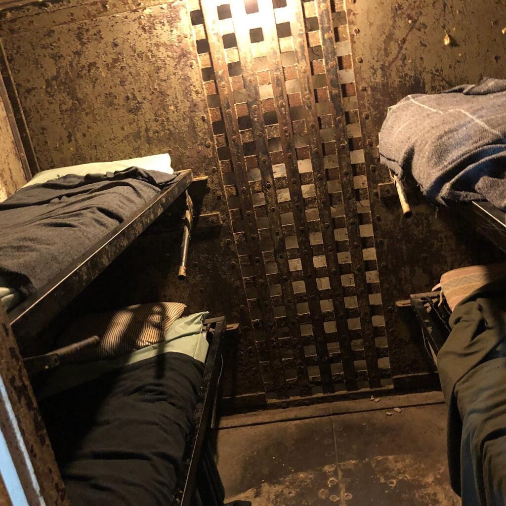 a jail cell with four beds