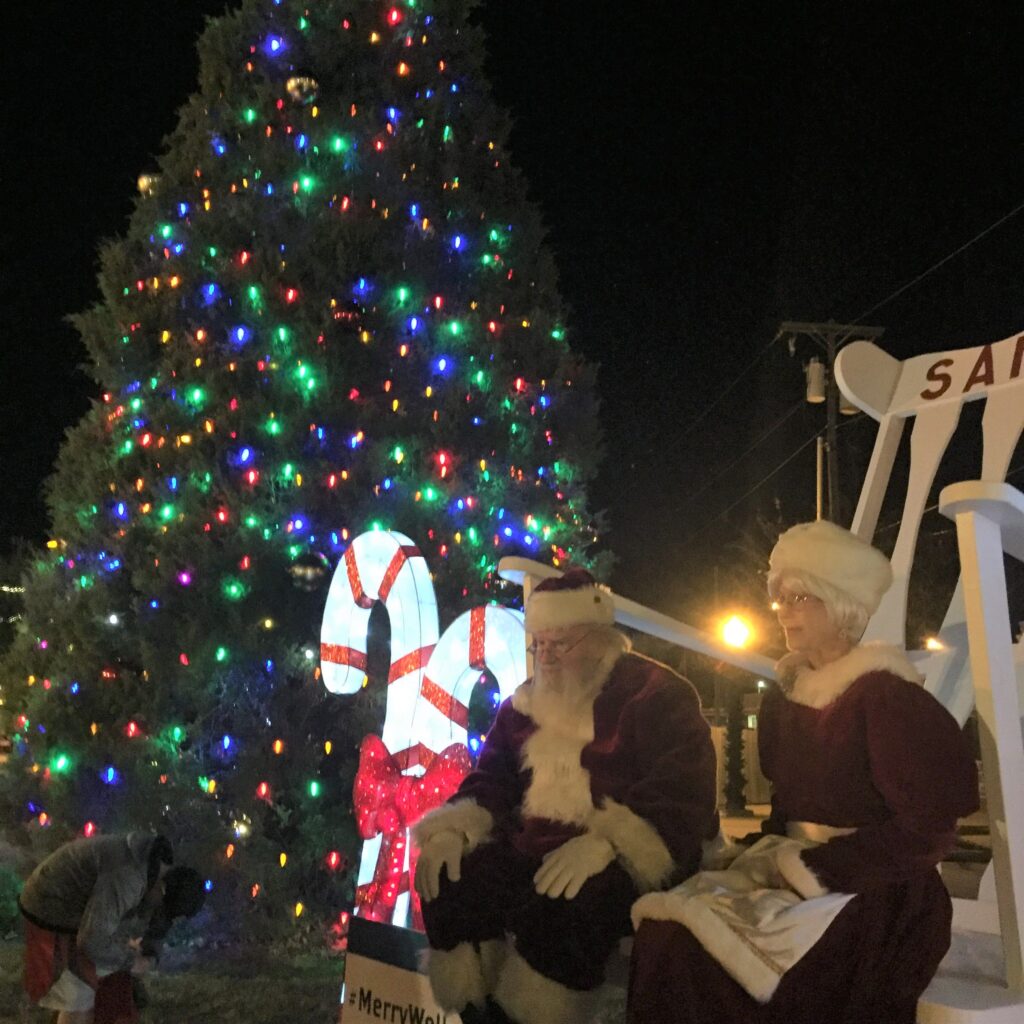 Santa and Mrs. Claus in front of Christmas tree in Mineral Wells
