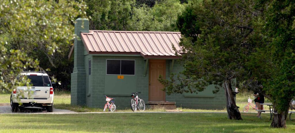 Cabin and car in the outdoors with bikes outside