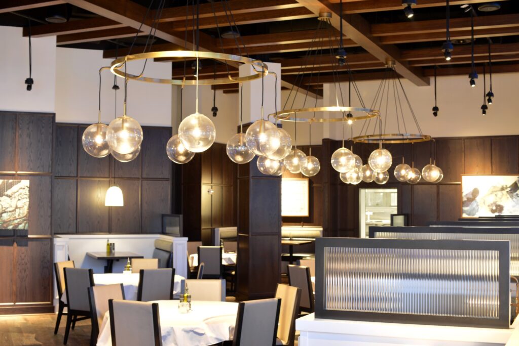Elegant booths and tables with white table cloths and sophisticated lighting at Conner's Steak and Seafood in Farragut, TN.
