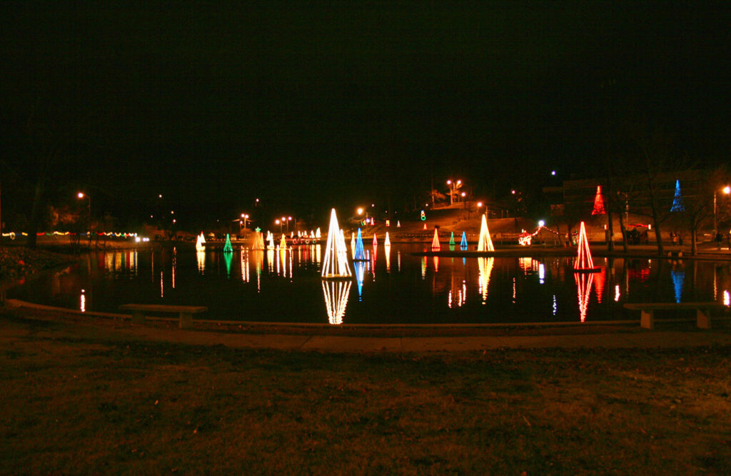 Lit up festive trees in a small lake. 