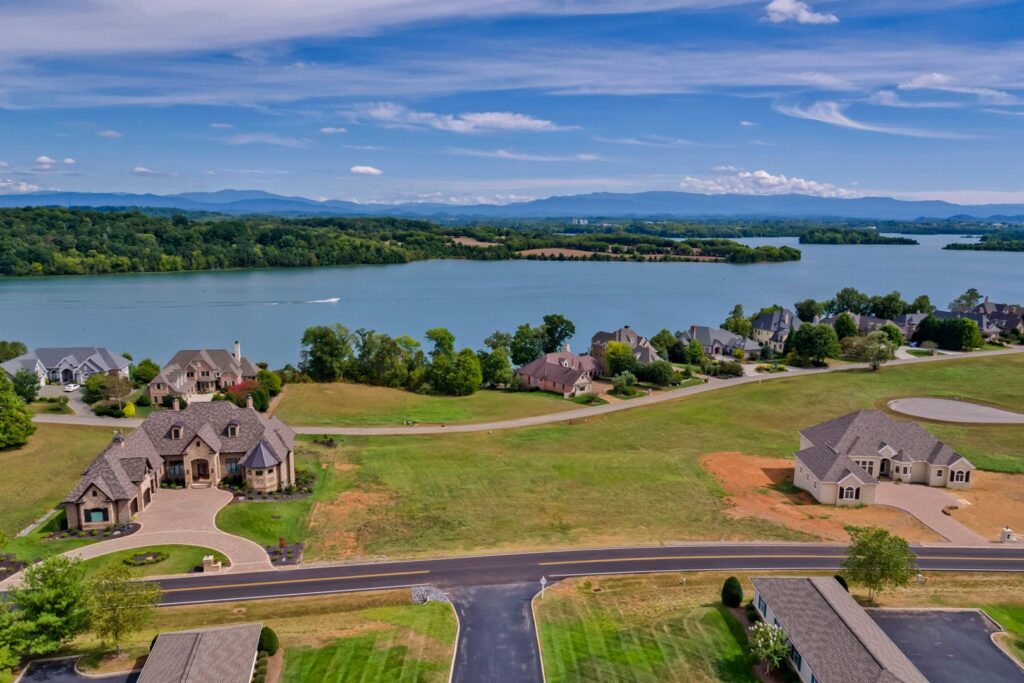 An aerial shot of Tellico Lake in Tennessee, featuring large homes and clear blue waters. 