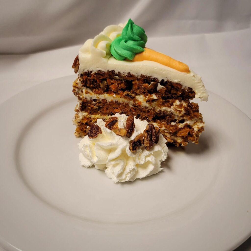 Carrot cake on a white plate. 