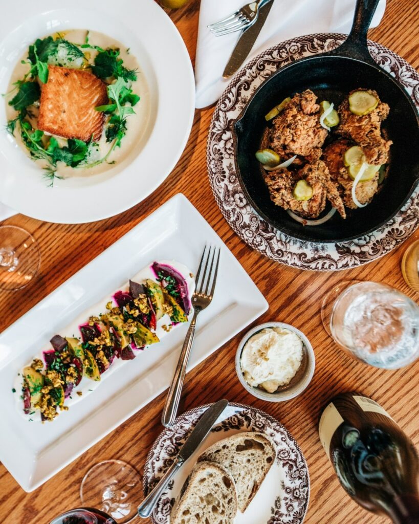 Fried Chicken, vegetables, and Salmon on picturesque plates at Tennessee's RT Lodge. 