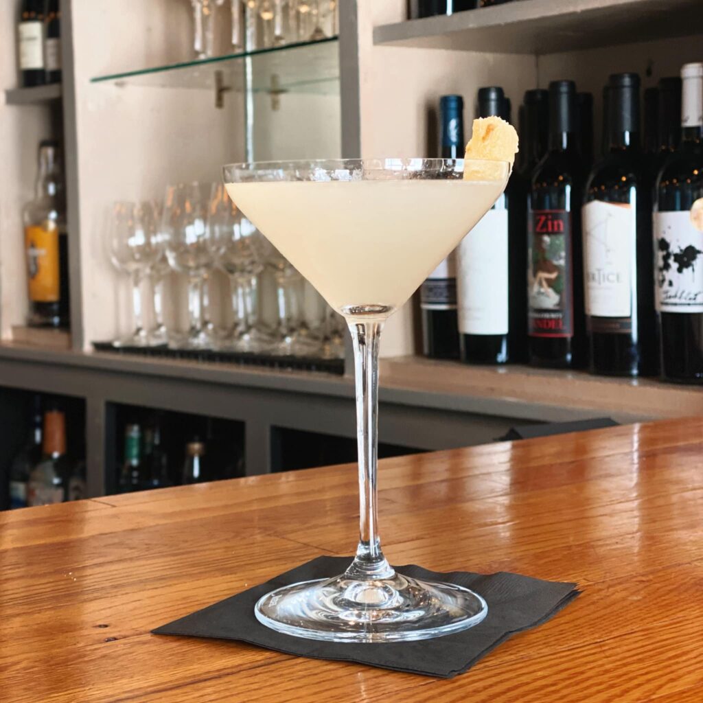 Lemon drop martini in front of bar. 