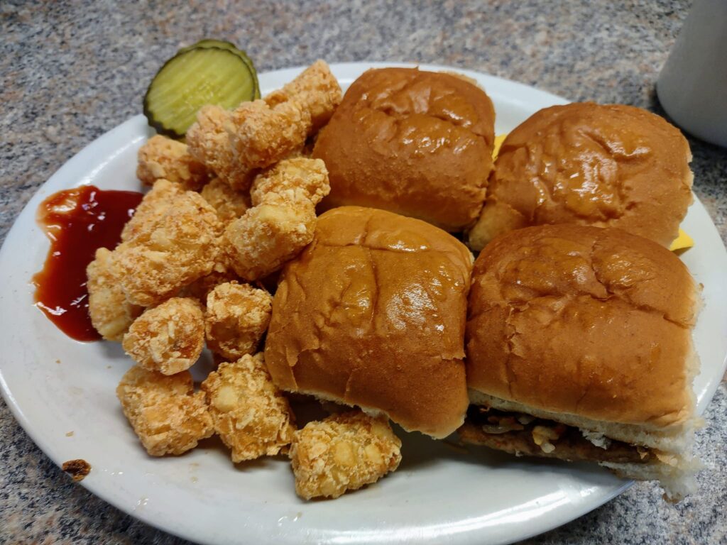 4 small burgers with tater tots.