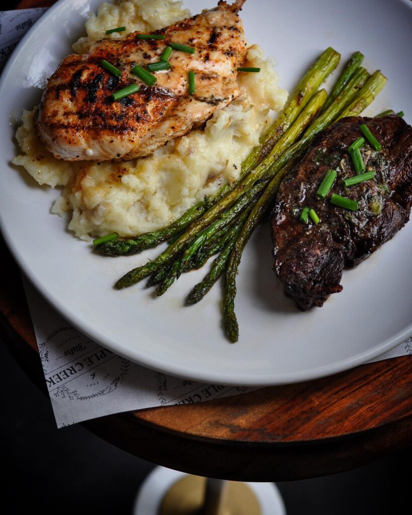 surf and turf plate---chicken and steak with mashed potatoes and asparagus