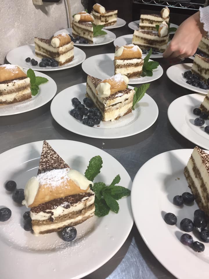 Many plates of Italian cake