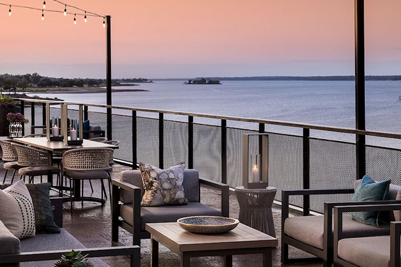 Patio with tables and chairs overlooking Grapevine Lake in Texas.