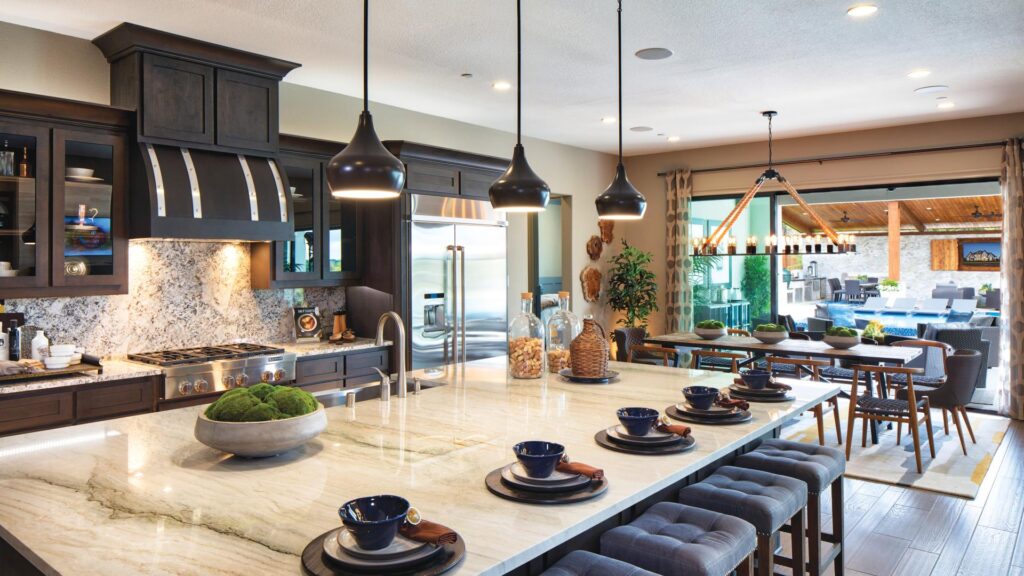 Modern kitchen with white countertops and black cabinets.
