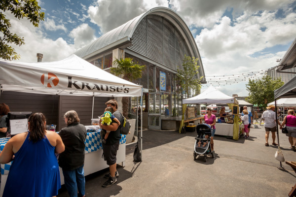exterior of a beer hall, tents and people in the road